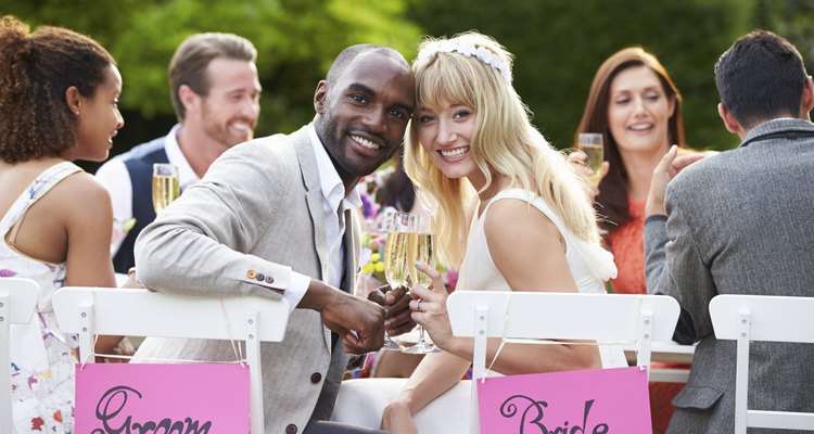 Bride And Groom Enjoying Meal At Wedding Reception