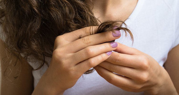 Female hand holding the hair ends