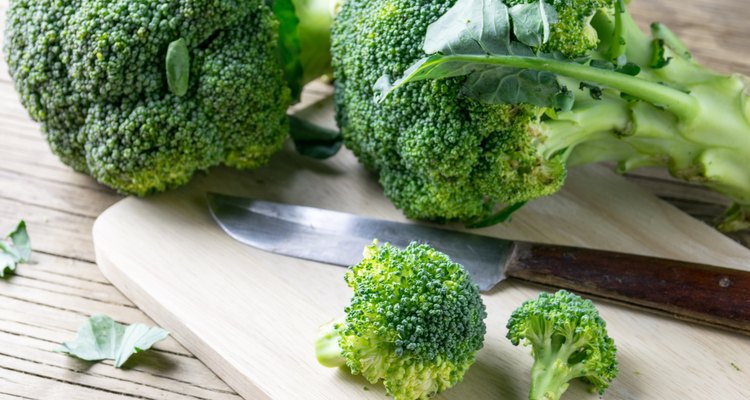 fresh broccoli on a cutting board and knife