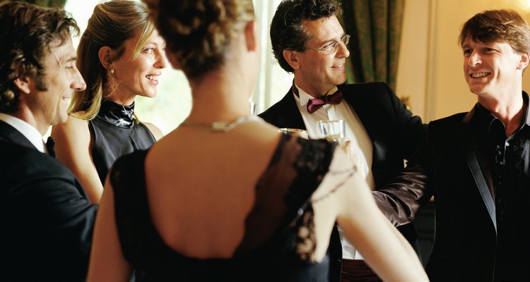 Group of people wearing formal attire indoors, smiling