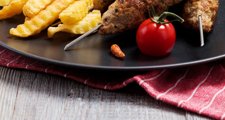 Barbecued kofta - kebeb with fries and vegetables