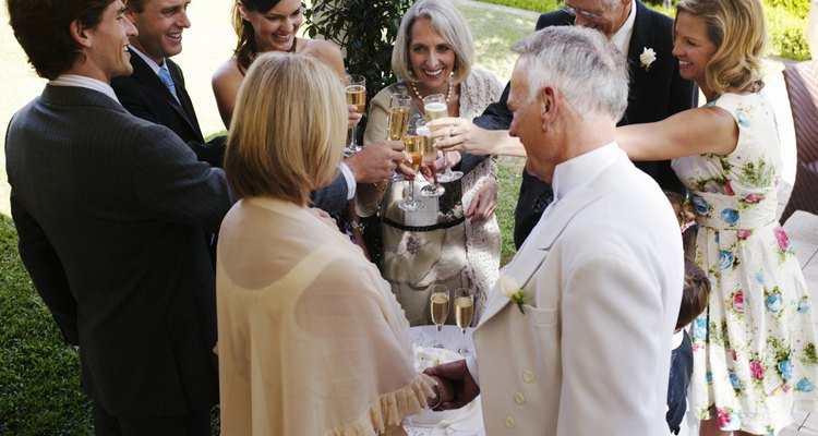 Bride and groom toasting with wedding guests, smiling