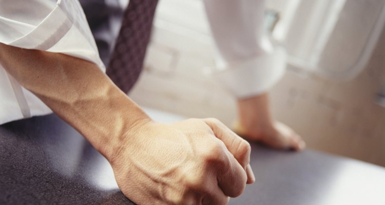 Clenched fists and a forward lean is meant to intimidate and gives a negative vibe.