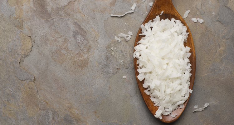 Coconut Flakes in Wooden Spoon