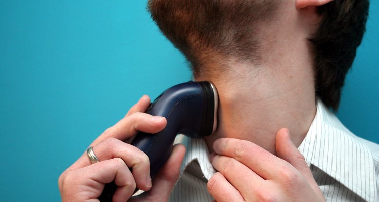 Man using electric shaver