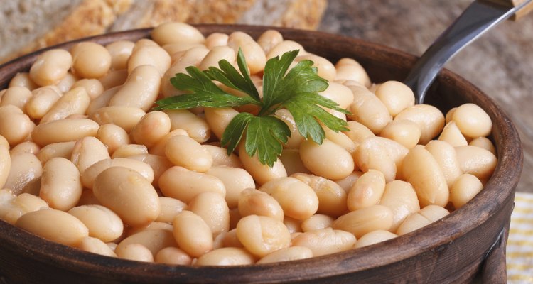 white kidney beans in a brown pot macro and bread