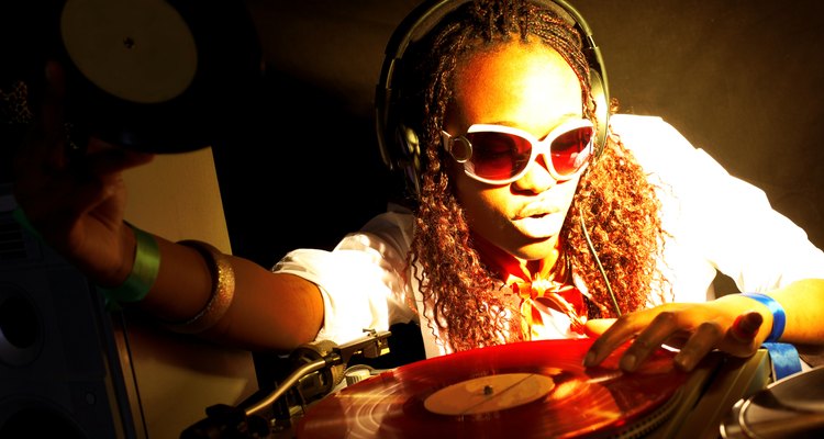 cool afro american DJ in action under yellow-red light