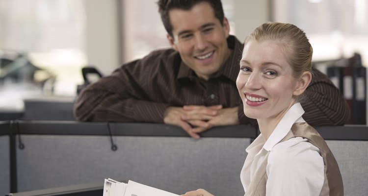 Finding reasons to talk to you at work may mean he's interested.