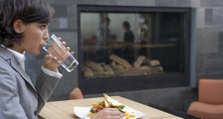 Businesswoman eating at restaurant