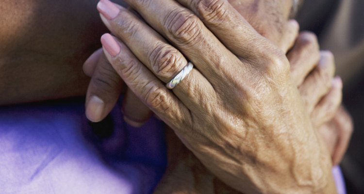 Embracing senior couple with wedding ring