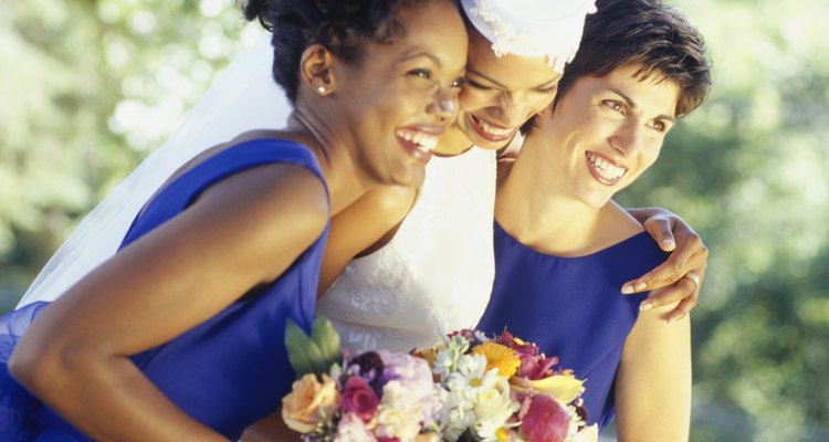 Bride with bridesmaids standing in garden