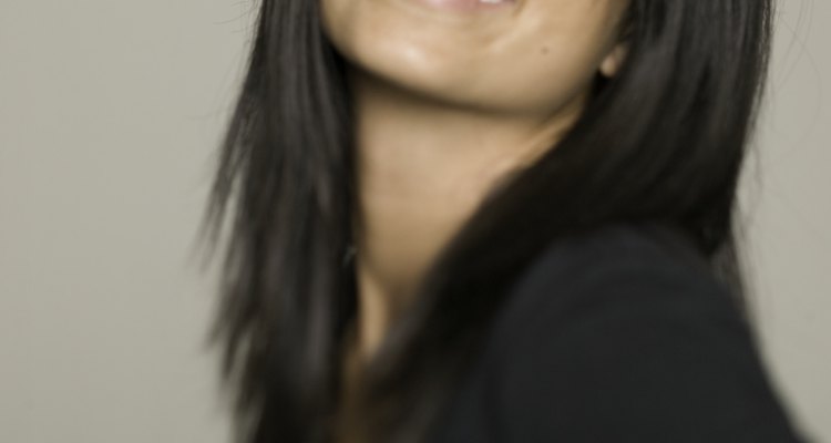 Woman with dark hair and dark eyes, posing in studio, portrait