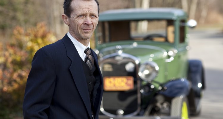 Man engages camera with Model A Ford in background