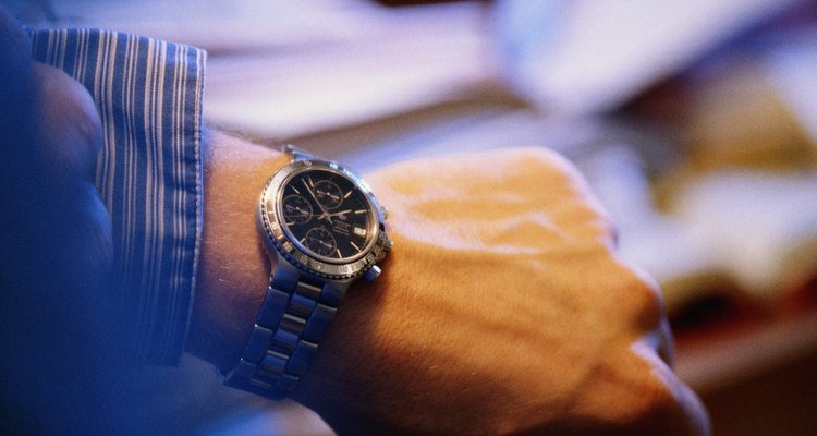 Man checking time on wrist watch, close-up