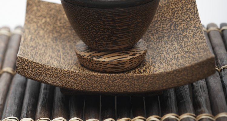 Mortar and pestle with sea salt atop bamboo mat