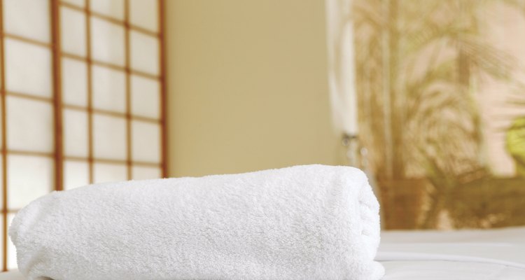 Rolled-up towel on massage table