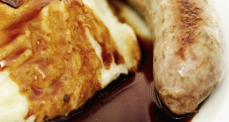 Close-up of sausages served with mash potatoes and gravy