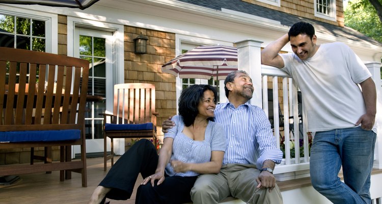 Parents and son talking on back porch