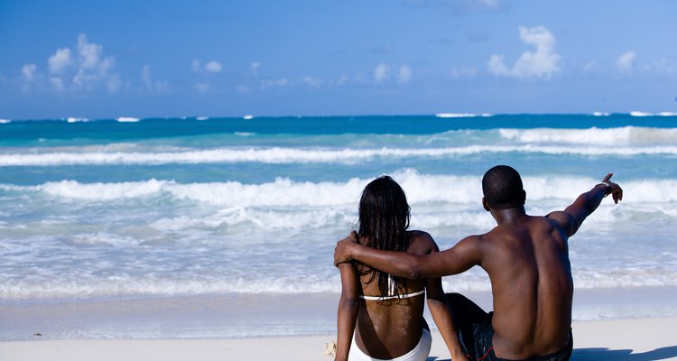 Couple sitting on beach, Dominican Republic