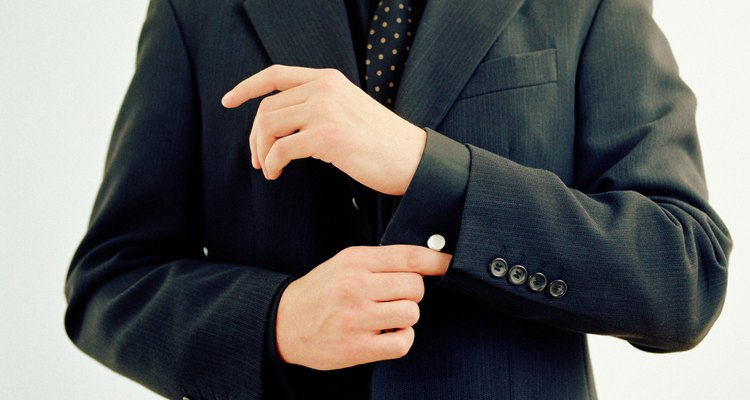 Businessman adjusting sleeve