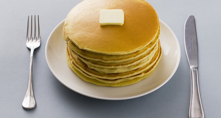 Stack of pancakes with butter on a plate