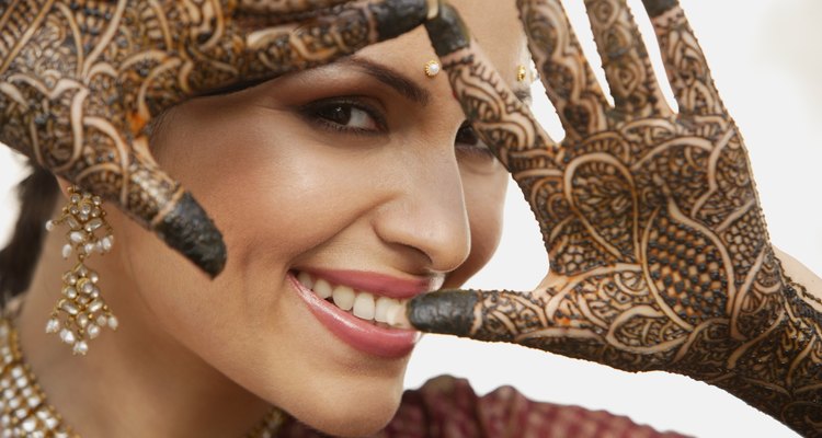 Woman with ornate henna design on hands