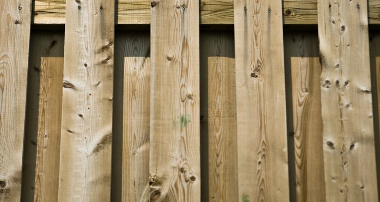 Erecting wall-like privacy fences becomes complicated on sloping ground.