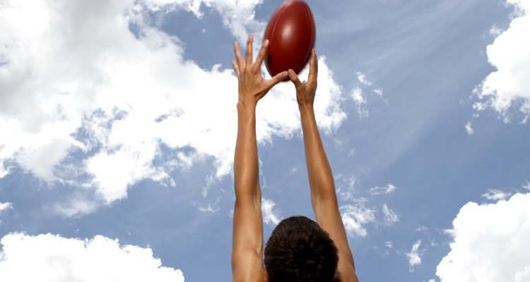 Player jumping to catch Australian football