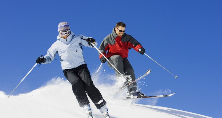 Couple downhill skiing