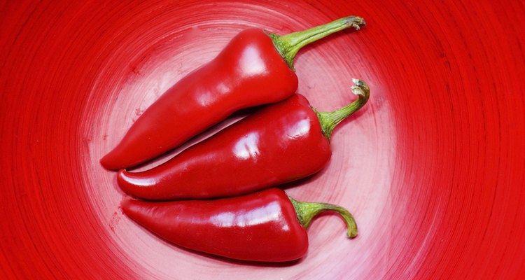 Close-up of three red chili peppers