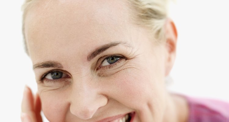 portrait of a mid adult woman smiling with her hand on her chin