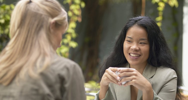 Asian woman talking to friend