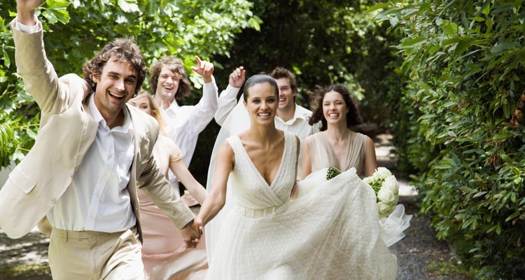 Wedding party running in garden