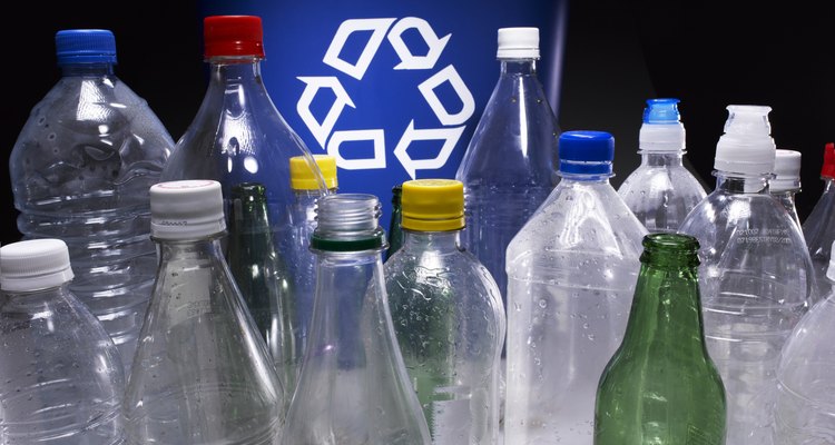 Assorted bottles and trash bin with recycle sign