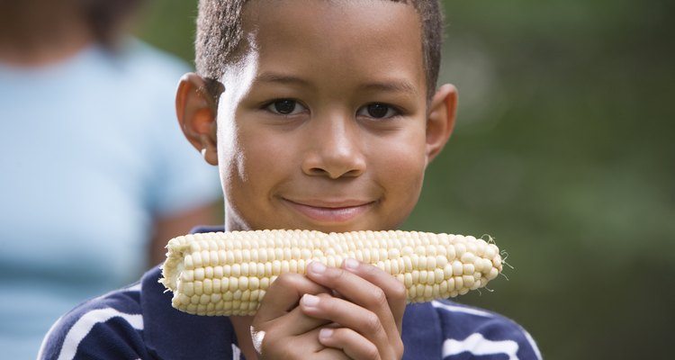 Boy holding ear of corn