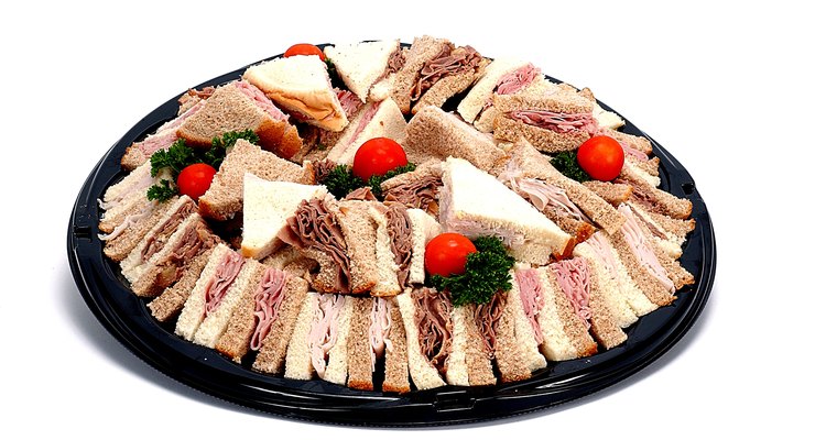 Arrange sandwiches cut in quarters with the crust on the tray.