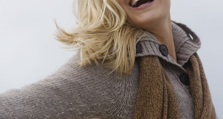 Smiling woman in sweater and scarf