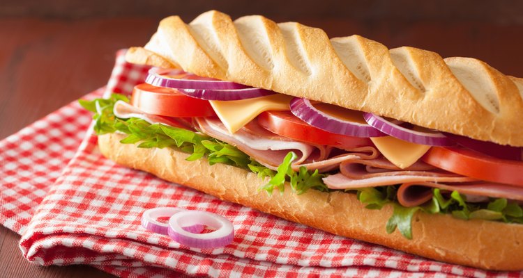 long baguette sandwich with ham cheese tomato lettuce