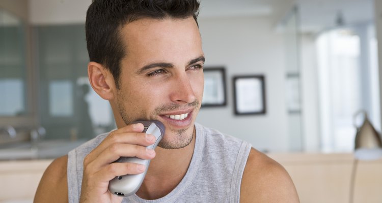 Man using electric shaver