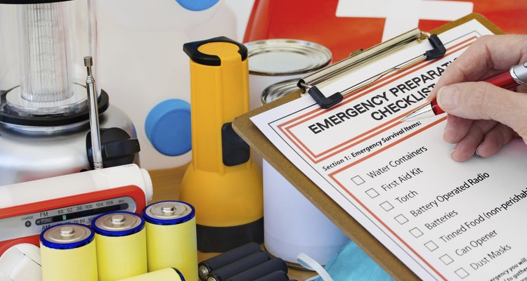 Hand completing Emergency Preparation List by Equipment