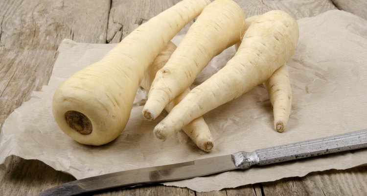 parsnip lie with a knife on brown paper