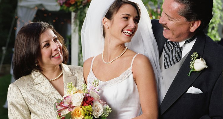 Bride posing for the camera with her parents