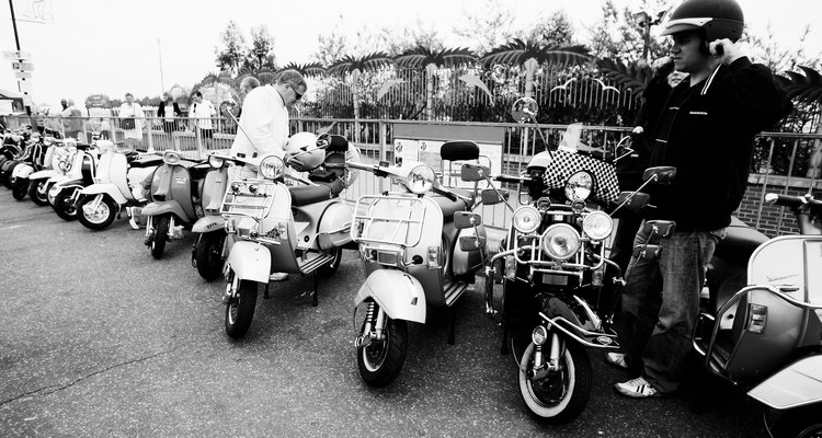 Vintage Vespa scooters use a fuel tap underneath the tank; you need to remove it.