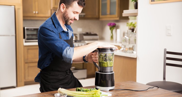 Young man making a smoothie