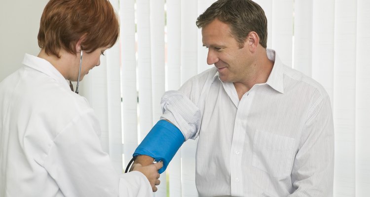 Doctor examining blood pressure on patient