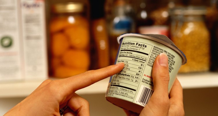 Person Reading Nutrition Label on Packaged Food