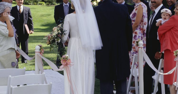 Bride and father walking down aisle at out door wedding ceremony