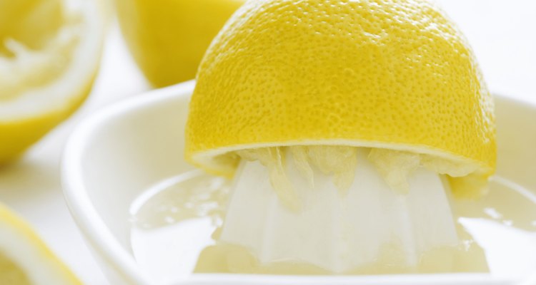 Lemon half and juice squeezer, close-up