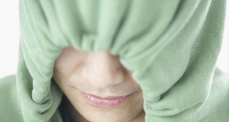 Close-up of teenage boy (16-17) wearing a hooded shirt