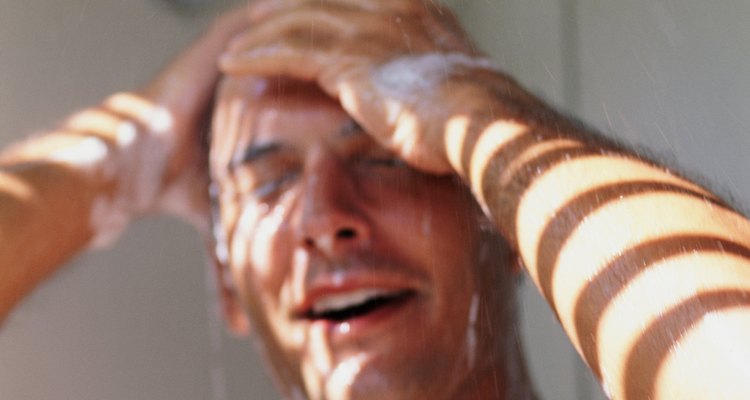 Man washing hair in shower